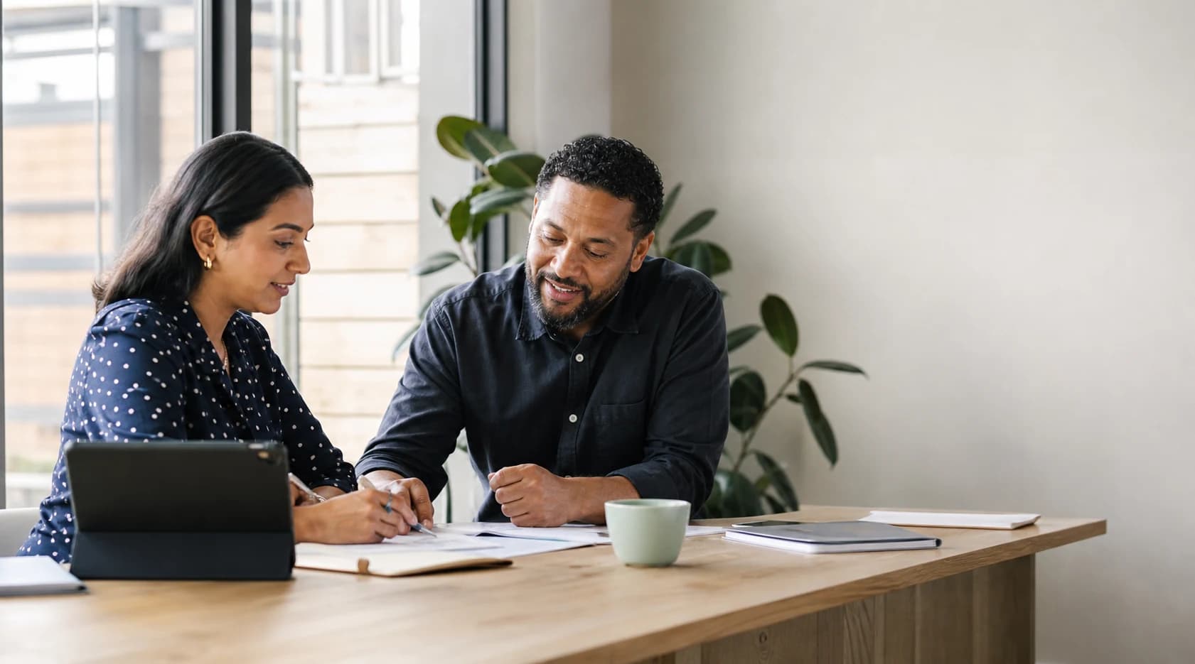 A Support Coordinator and disability support professional reviewing participant support information together